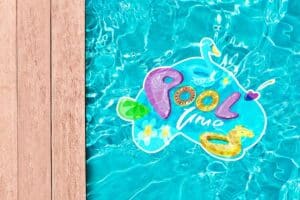product example of a pool decal shown inside a pool, a decal of a swan that has pool time written on it