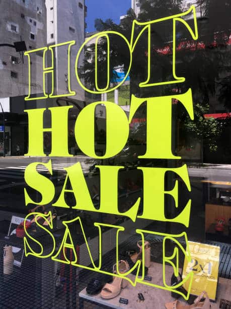 Buenos Aires, Argentina - February 3, 2019: Sale advertised in shoes store window. The current economic crisis forces the shop owners to offer huge discounts in order to sell their merchandise