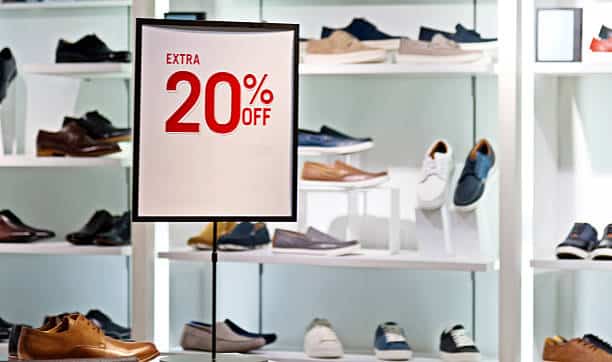 Men shoe store with "extra 20% off" sign on the plate.
