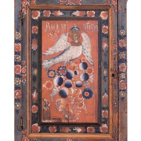 Olonets, Karelia, Russia - May 8, 2021: Wooden wedding capboard, late 18 - early 19th century. Sirin is mythological creature of Russian legends, with the head and chest of a beautiful woman.